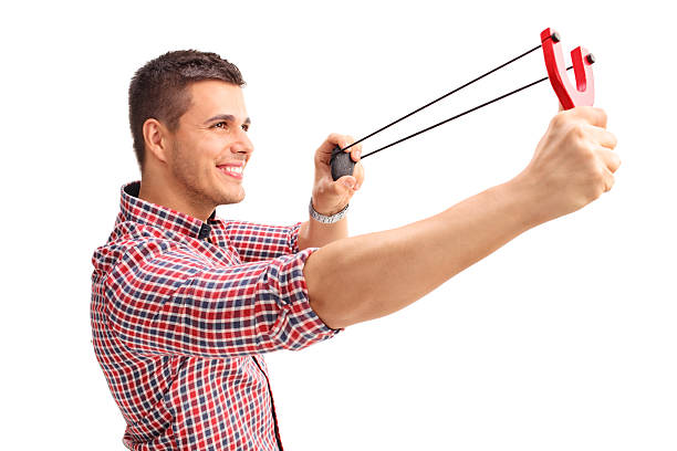 istock Cheerful man shooting a slingshot and smiling 488471530