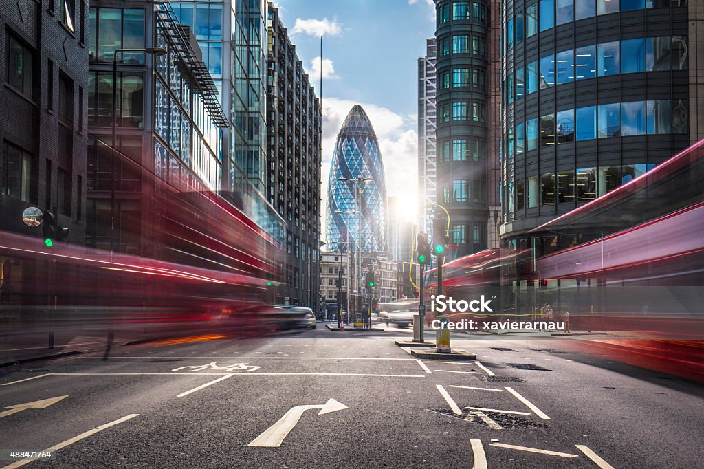 Financial district of London Buses on the street at the financial district of London. London - England Stock Photo