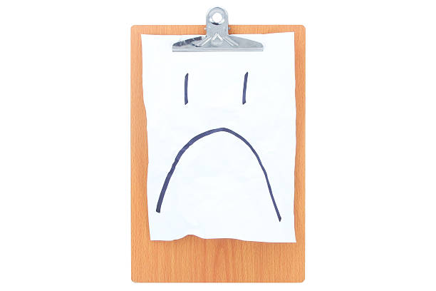 Wooden Clipboard with white rough paper and a sad face