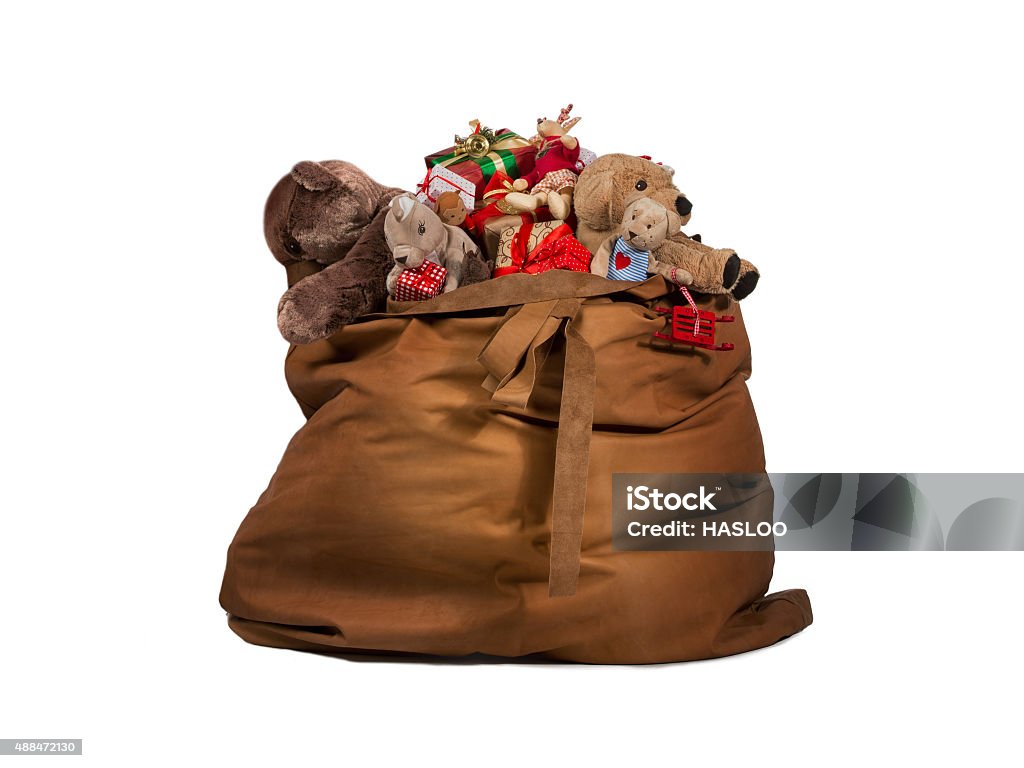 Santa Claus gift bag full of toys and gifts Santa Claus gift bag full of toys and gifts isolated over white background Bag Stock Photo