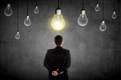 Business person having a bright idea light bulb concept. Business creative conceptual
