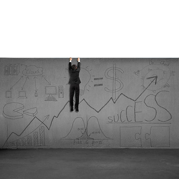 istock Man trying to climb over wall with business doodles 488472957
