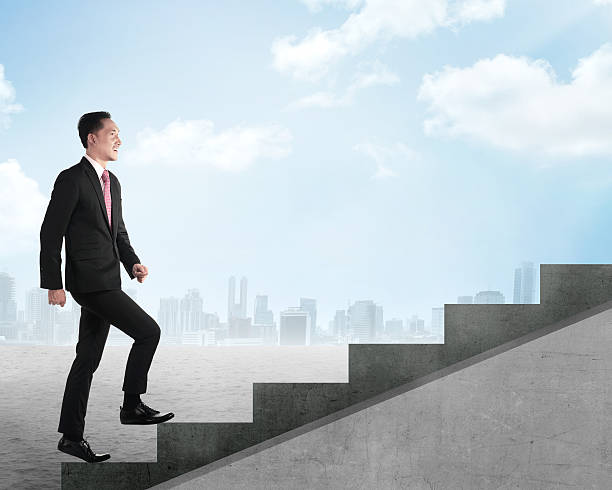 istock Confident business person walking upstairs 488473064