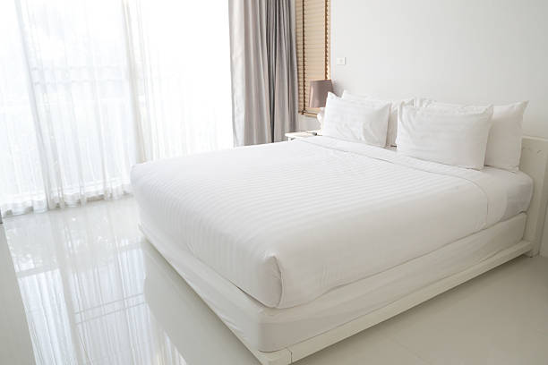 White bed sheets and pillows White bed sheets and pillows bed stock pictures, royalty-free photos & images