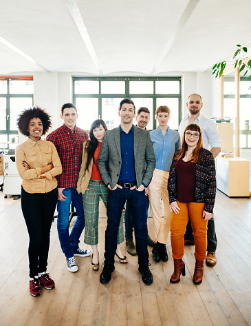 Vertical shot of a new business team in office loft in Berlin, Germany