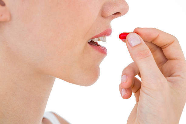 istock Pretty woman ready to swallow red pill 488476102