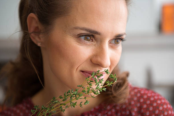 istock Closeup of woman smelling fresh thyme 488476532