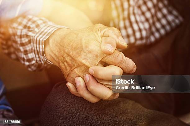 Nephew Holding Strong Grandfathers Hand Stock Photo - Download Image Now - Sunlight, Senior Men, Assistance