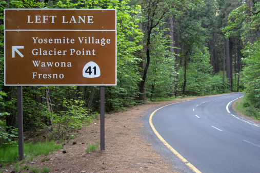 Signs for highway 41 and various points in Yosemite National Park, one of the gems of the US National Park Service. This beautiful national park is the site of many of photographer's most famous photographs.