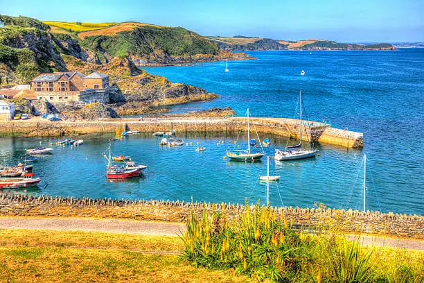 Mevagissey harbour Cornwall England blue sea and sky on a beautiful summer day in vibrant and colourful HDR