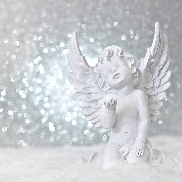 istock little white guardian angel in snow 488478913
