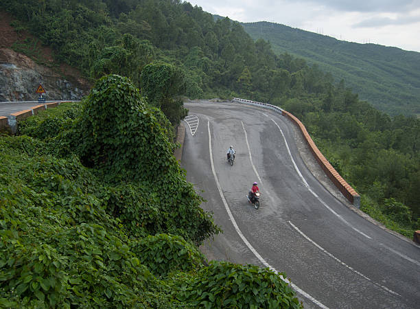 Mountain road on Hai Van pass in Hue Hue, Vietnam - September 26, 2009: Motorbike running on the mountain road in Hai Van pass, Hue province, Vietnam. Hai Van is the most spectacular highway in Vietnam. central highlands vietnam photos stock pictures, royalty-free photos & images