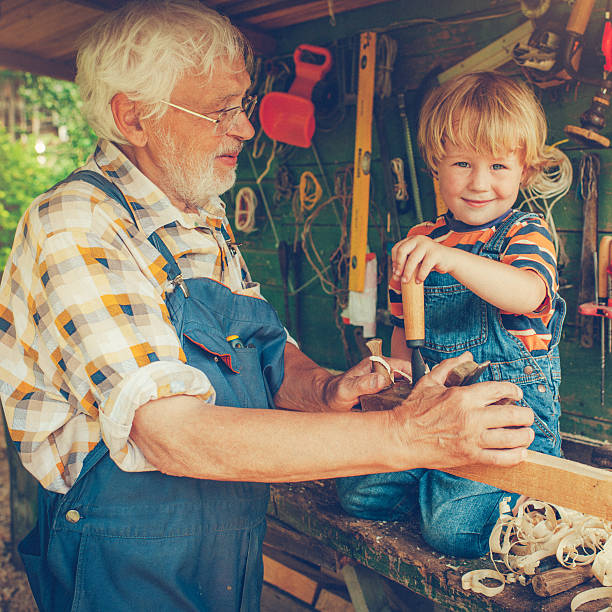 istock Grandfather and grandson in workshop 488479133