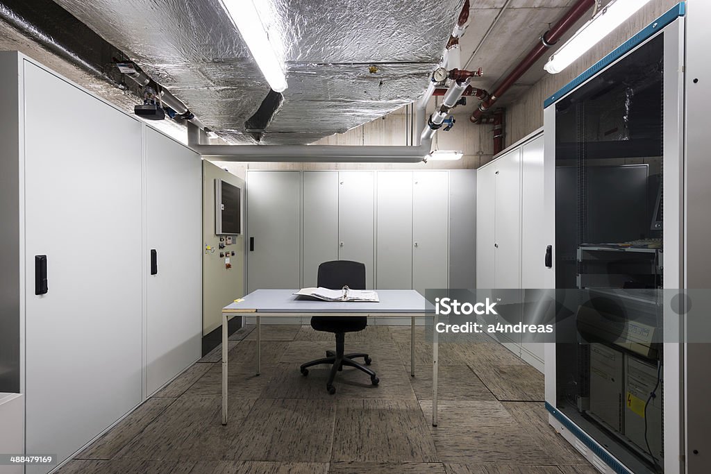 technical room with electronic equipment with table and chair Law Stock Photo