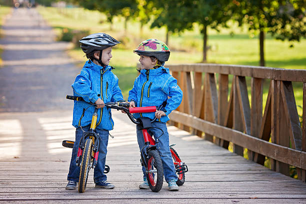 istock Two cute boys, siblings children, having fun on bikes 488482414