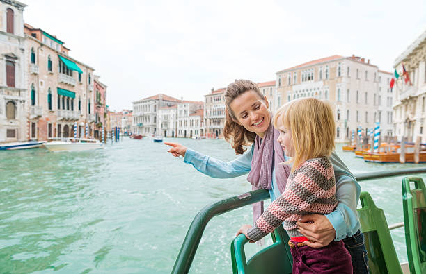 istock Mother pointing out sights to daughter while on boat ride 488482698