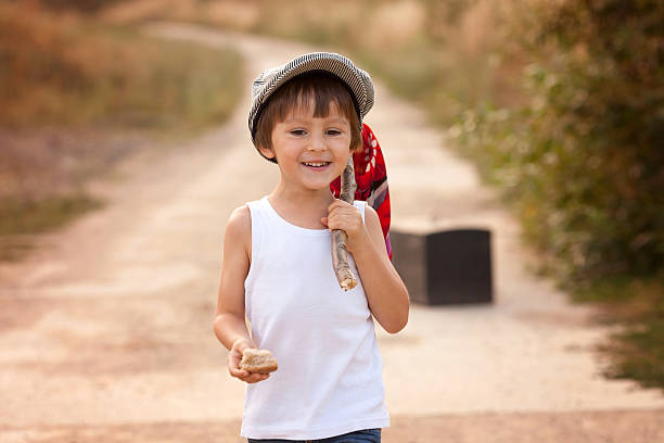istock Cute little boys, holding a bundle, eating bread and smiling 488482820