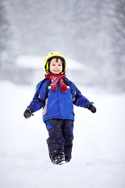 istock Happy baby boy playing in the snow 488483782