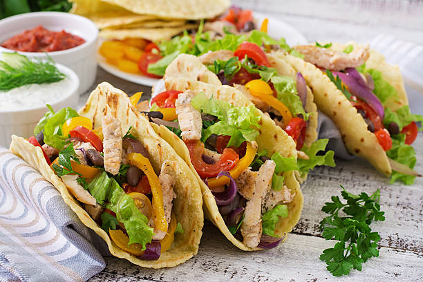 istock Mexican tacos with chicken, bell peppers, black beans 488484024