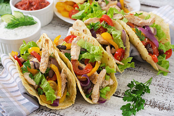 istock Mexican tacos with chicken, bell peppers, black beans 488484126