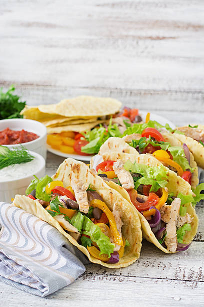 istock Mexican tacos with chicken, bell peppers, black beans 488484678