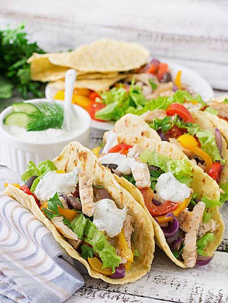 istock Mexican tacos with chicken, bell peppers, black beans 488484810