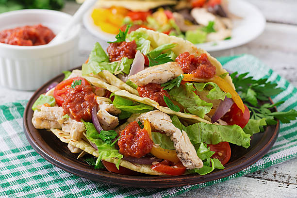 istock Mexican tacos with chicken, bell peppers, black beans 488485208