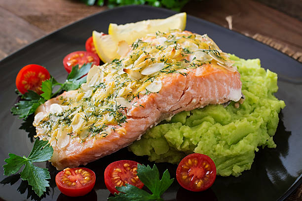 istock Baked salmon with cheese and almond crust and garnished 488486360