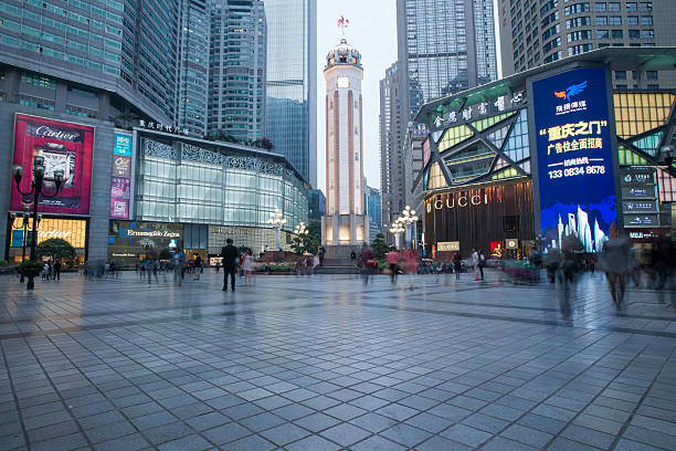 Chongqing,China - April 8, 2014: People walking in Business center of Chongqing at night,Chongqing is a major city in the west south of China.Now it developed into an international city.Jiefangbei is Business center of Chongqing, there are lots of Skyscraper.