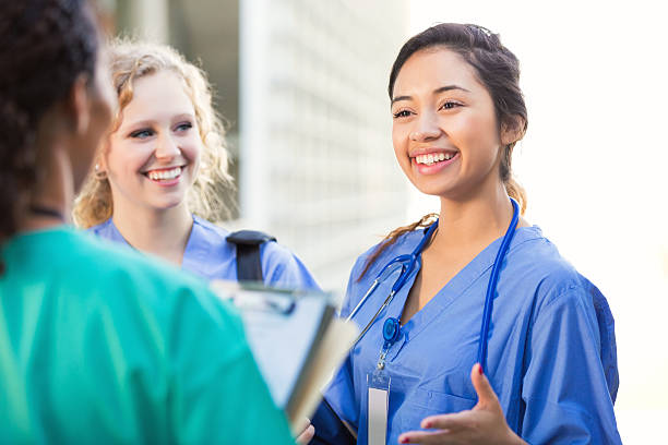 amamentar os estudantes falando juntos na college campus - medical student healthcare and medicine book education - fotografias e filmes do acervo