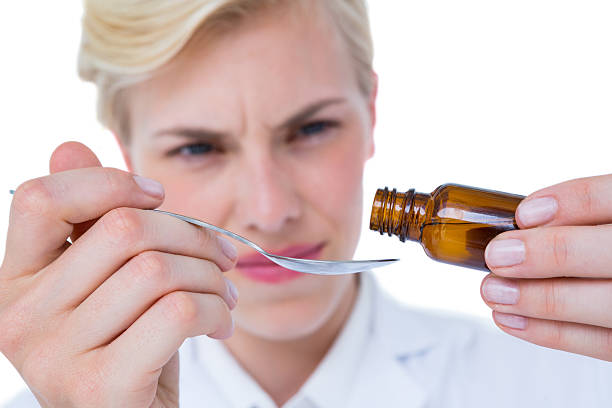 istock Doctor pouring medicine in spoon 488489356