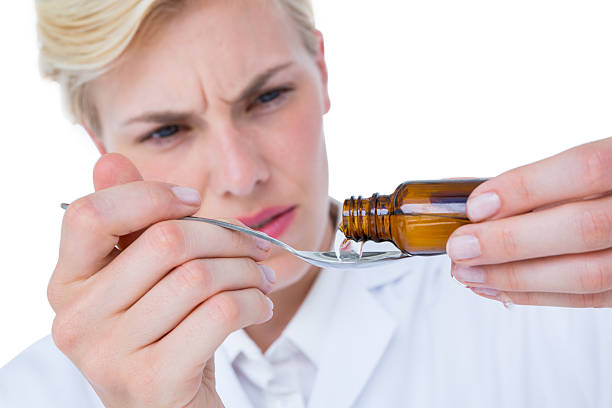 istock Doctor pouring medicine in spoon 488489390