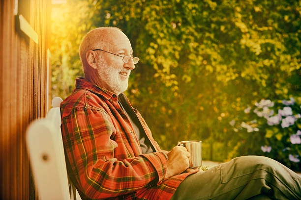 istock Retired man enjoying his garden with a cup of coffee 488489714