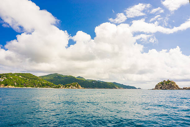 istock Green island with blue sky and sea 488490750
