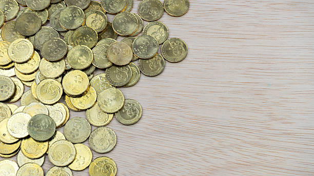 istock Top view coins on wooden desk surface with copy space 488491288