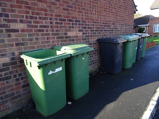 istock Image of wheelie bins lined up for refuse collection / bin-men 488491312
