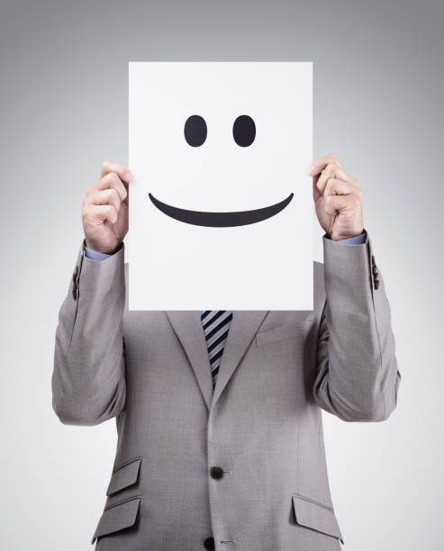istock Businessman holding card with smiley face 488491396