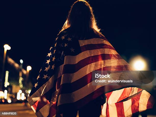 Woman Draped With American Flag On City Street At Night Stock Photo - Download Image Now