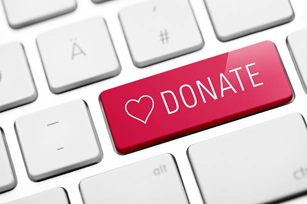 online donate key on keyboard - schenking stockfoto's en -beelden