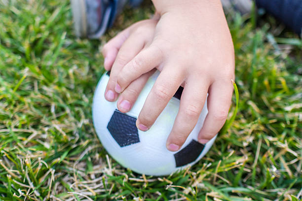 istock little boy is holding a ball with his both hands 488493962