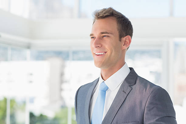 istock Smiling businessman looking away 488495580