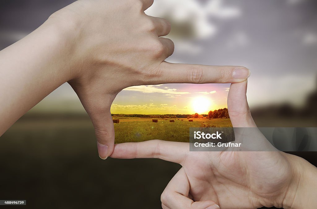clear vision of a sunset out of focus nature and fingers creating a square making the scenery better The Way Forward Stock Photo