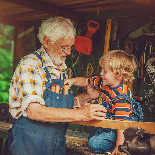istock Grandfather and grandson in workshop 488497065