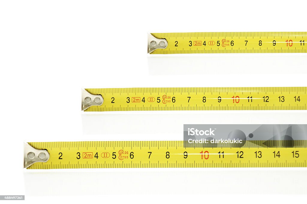 Tape Measure Three yellow tape measure. Isolated on white background. Accuracy Stock Photo