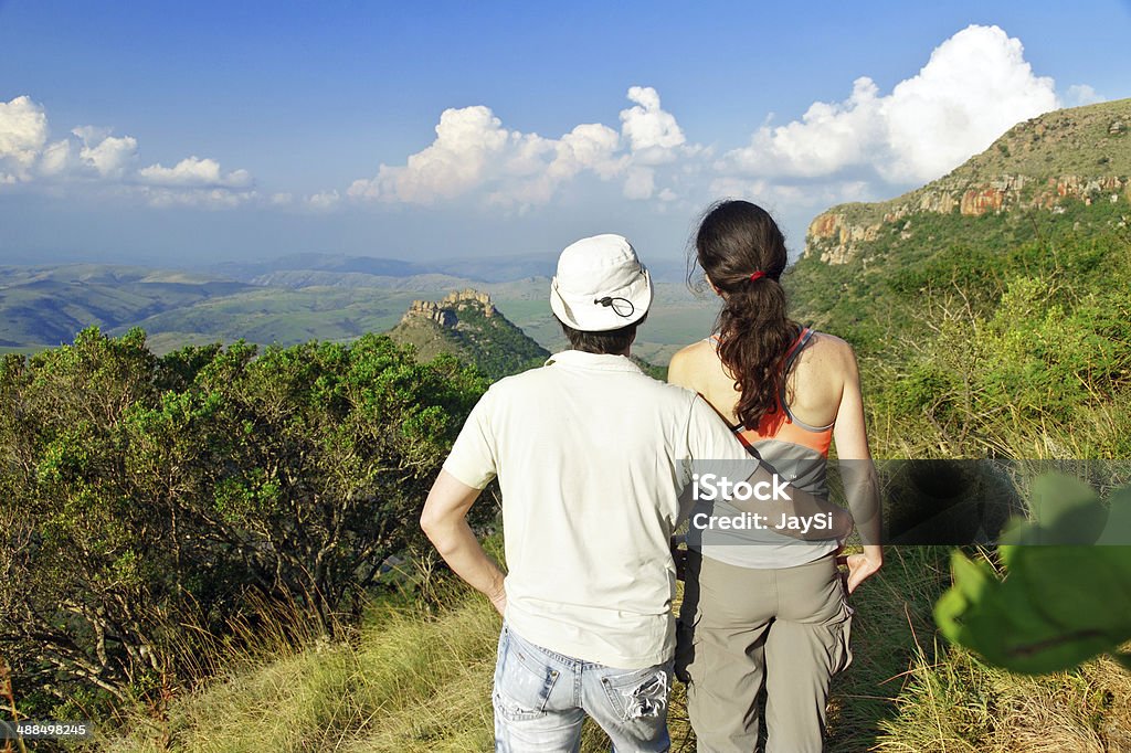 Happy couple hiking in mountains Happy couple trekking in mountains, hiking tourists looking at beautiful view, South Africa Active Lifestyle Stock Photo