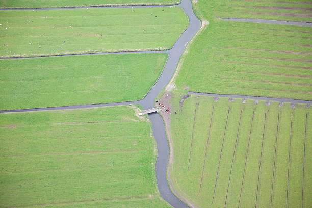 istock Green landscape with water and bridge from above, The Netherlands 488498617