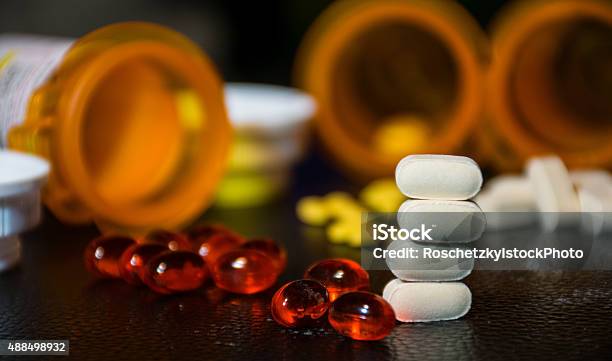 Stacked Pills Softgels Open Bottles Blurred Background Medicine Stock Photo - Download Image Now