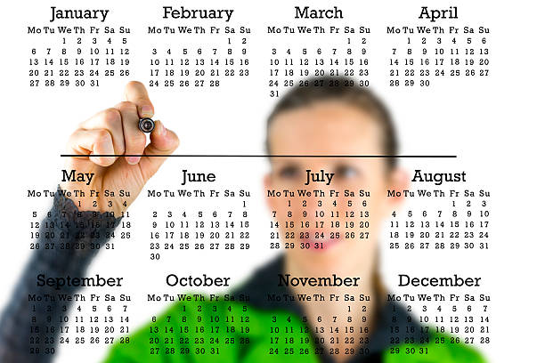 istock Virtual calendar with a woman writing in copyspace 488499107