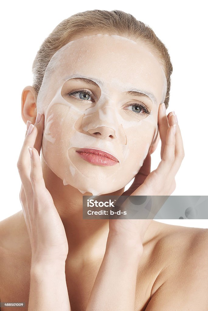 Beautiful young woman with collagen mask. Beautiful young woman with collagen mask. Isolated on white. Adult Stock Photo