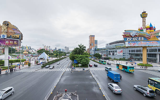 Shenzhen, China - September 2, 2015: High angle view of busy traffic on Shennan road on a cloudy day near Happy Valley park and Window of the World park. Shennan road is the main street across Shenzhen City.